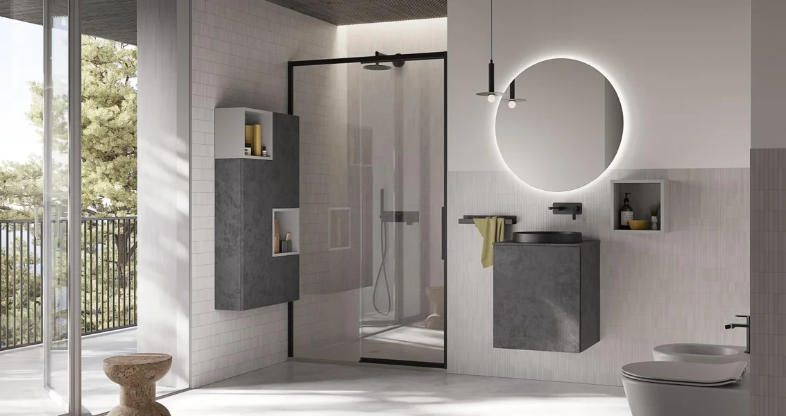 Bagno grigio con box doccia e specchio tondo